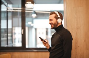 Man enjoying user experience through wireless music powered by apps